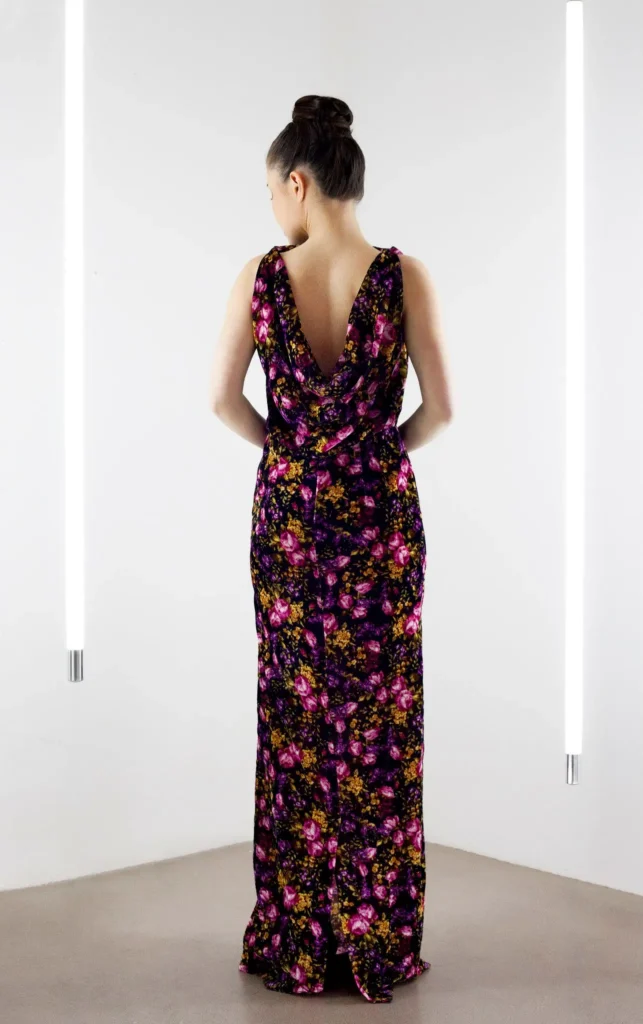 Back view of the black velvet floral dress featuring a draped cowl neckline.